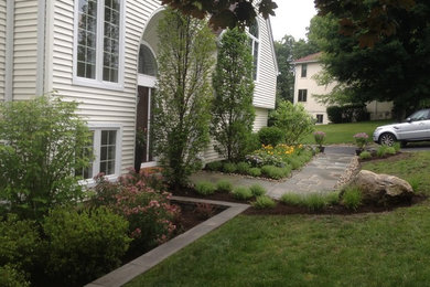 Photo of a small front yard partial sun garden in New York with natural stone pavers.