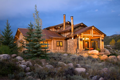 Inspiration for a rustic wood exterior home remodel in Denver with a metal roof