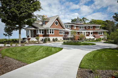Inspiration for a large coastal brown three-story wood exterior home remodel in New York with a shingle roof