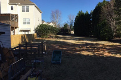 Inspiration for a mid-sized tropical side yard rectangular natural pool remodel in Atlanta with decking