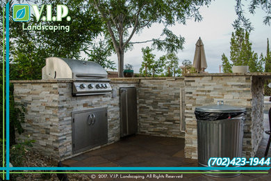 Inspiration for a large craftsman backyard concrete paver landscaping in Las Vegas.