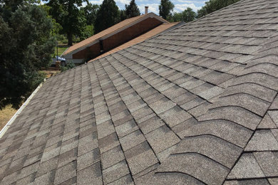 Example of a 1950s exterior home design in Denver with a hip roof and a shingle roof