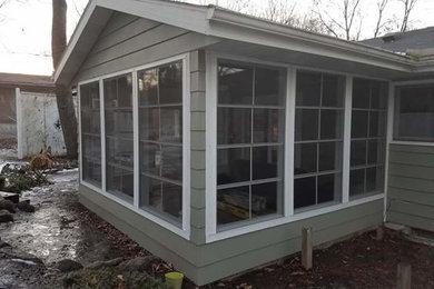 Mid-sized trendy tile screened-in back porch photo in Other with a roof extension