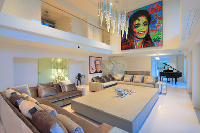 Example of a large trendy open concept light wood floor, beige floor and coffered ceiling living room design in Los Angeles with gray walls
