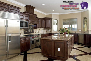Inspiration for a large timeless u-shaped ceramic tile and beige floor kitchen pantry remodel in Los Angeles with an undermount sink, shaker cabinets, dark wood cabinets, granite countertops, beige backsplash, ceramic backsplash, stainless steel appliances and an island