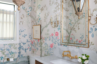 Inspiration for a wallpaper powder room remodel in Houston with medium tone wood cabinets, an undermount sink, quartz countertops, white countertops and a freestanding vanity
