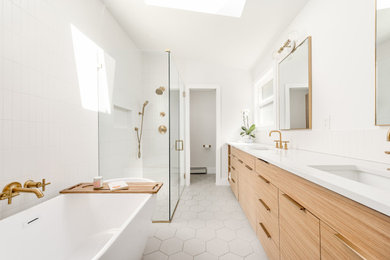 Bathroom - mid-sized 1960s master white tile and ceramic tile porcelain tile, gray floor, double-sink and vaulted ceiling bathroom idea in Denver with flat-panel cabinets, light wood cabinets, a two-piece toilet, white walls, an undermount sink, quartz countertops, a hinged shower door, white countertops, a niche and a built-in vanity