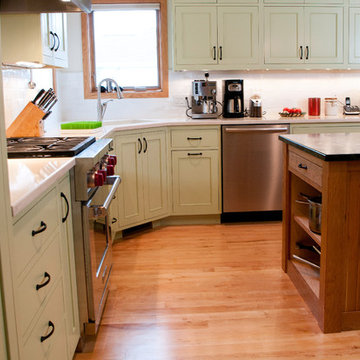 Green inset cabinet with cherry island.