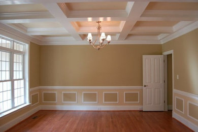 Example of a medium tone wood floor living room design in Richmond with yellow walls