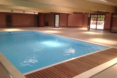 This is an example of a mid-sized contemporary indoor rectangular pool in Surrey.
