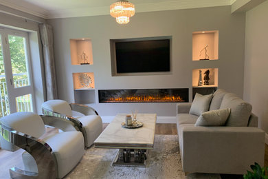 Medium sized contemporary formal and grey and white open plan living room in Buckinghamshire with white walls, vinyl flooring, a ribbon fireplace, a plastered fireplace surround, a built-in media unit, brown floors, a coffered ceiling, panelled walls and feature lighting.