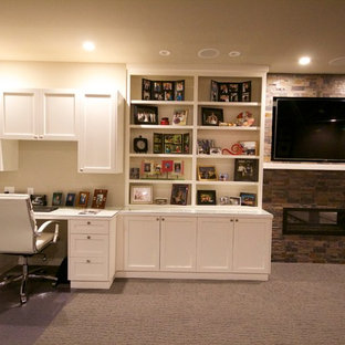 Photo of a medium sized modern study in Seattle with grey walls, carpet, a two-sided fireplace, a tiled fireplace surround and a built-in desk.