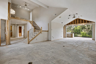 Family room - huge traditional open concept laminate floor, brown floor and exposed beam family room idea in Houston with white walls