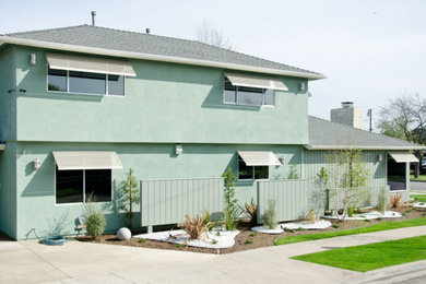 Inspiration for a mid-century modern green two-story mixed siding and board and batten house exterior remodel in Los Angeles