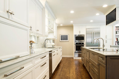 Kitchen - large transitional single-wall medium tone wood floor and brown floor kitchen idea in Denver with an undermount sink, stainless steel appliances, white backsplash, stone slab backsplash, recessed-panel cabinets, white cabinets and an island