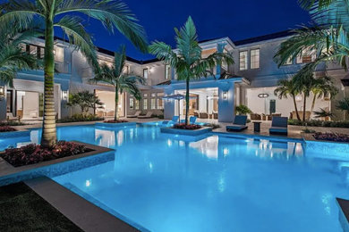 Inspiration for a large coastal backyard custom-shaped pool landscaping remodel in Other