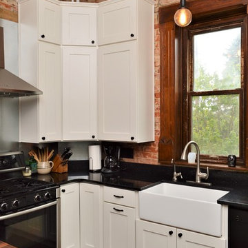 Bourbon, IN. Haas Signature Collection. Farmhouse Kitchen with Exposed Brick