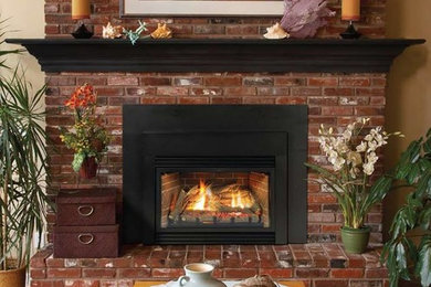 Example of a mid-sized classic formal and open concept medium tone wood floor and brown floor living room design in Omaha with beige walls, a standard fireplace, a brick fireplace and no tv