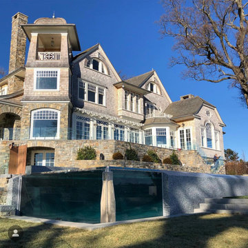 vanishing edge glass wall pool + raised perimeter overflow spa