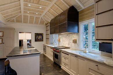 Large elegant single-wall dark wood floor enclosed kitchen photo in Charlotte with a farmhouse sink, white cabinets, marble countertops, white backsplash, stone slab backsplash, stainless steel appliances and an island