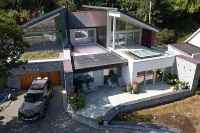 This is an example of a large nautical two floor front detached house in Other with mixed cladding and a purple house.