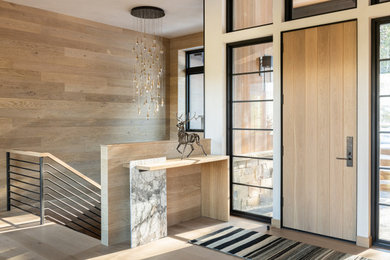 Large mountain style wood wall entryway photo in Other