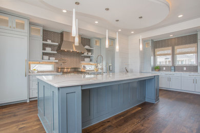 Inspiration for a transitional kitchen remodel in Wilmington with shaker cabinets, quartzite countertops, paneled appliances and an island