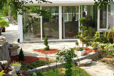 Inspiration for a mid-sized backyard concrete paver patio remodel in Omaha with no cover