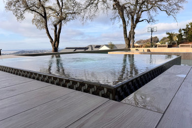 Mid-sized minimalist backyard tile and custom-shaped pool photo in Sacramento