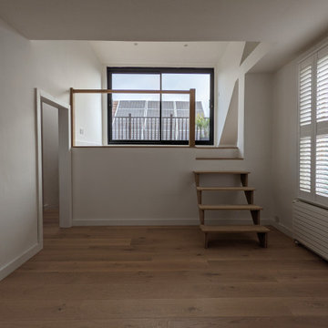 Quirky flat transformed by wide engineered oak boards & waterfall stair cladding