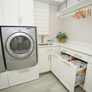 This is an example of a medium sized victorian l-shaped separated utility room in Other with a submerged sink, recessed-panel cabinets, white cabinets, marble worktops, grey walls, ceramic flooring, a side by side washer and dryer and grey floors.