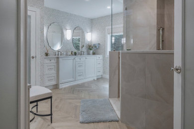 Large transitional master beige tile and travertine tile ceramic tile, beige floor, double-sink, vaulted ceiling and wallpaper bathroom photo in Philadelphia with beaded inset cabinets, white cabinets, a two-piece toilet, blue walls, an undermount sink, quartzite countertops, white countertops and a built-in vanity