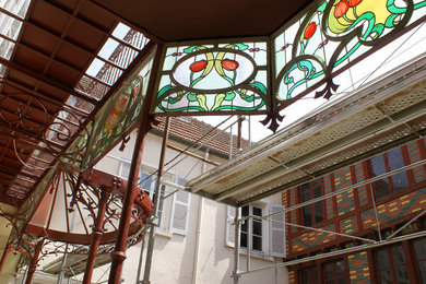 Photo of an expansive arts and crafts sunroom in Other with a glass ceiling.