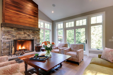 Inspiration for a contemporary formal and open concept medium tone wood floor living room remodel in Toronto with gray walls, a standard fireplace, a stone fireplace and no tv