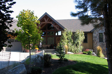 Mountain style brown one-story wood exterior home photo in Seattle
