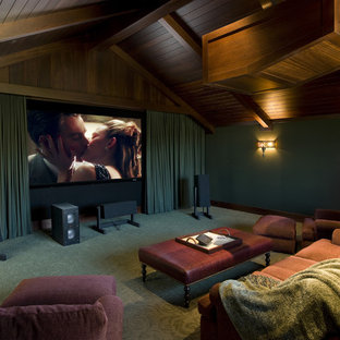 Example of a mid-sized coastal enclosed carpeted and green floor home theater design in Santa Barbara with green walls and a projector screen