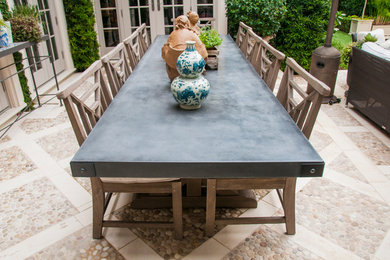 Example of a mid-sized tuscan backyard stone patio design in Miami with no cover