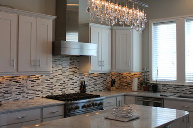 Open concept kitchen - mid-sized transitional u-shaped dark wood floor open concept kitchen idea in Cedar Rapids with a single-bowl sink, shaker cabinets, white cabinets, marble countertops, multicolored backsplash, stainless steel appliances and an island