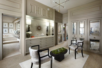 This is an example of a large transitional gender-neutral dressing room in Chicago with grey cabinets, carpet and flat-panel cabinets.