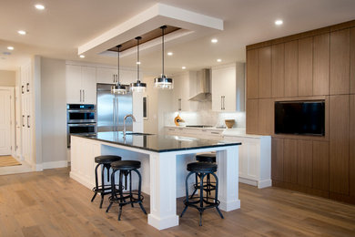 This is an example of a modern kitchen in Calgary with medium hardwood floors and brown floor.