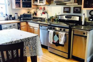 Open concept kitchen - mid-sized country l-shaped light wood floor and beige floor open concept kitchen idea in Boston with an undermount sink, raised-panel cabinets, light wood cabinets, granite countertops, stainless steel appliances and an island