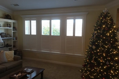 Inspiration for a mid-sized timeless enclosed carpeted living room remodel in Other with yellow walls, no fireplace and no tv