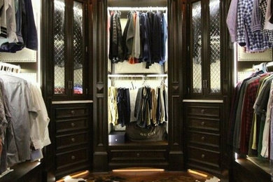Walk-in closet - large contemporary men's medium tone wood floor walk-in closet idea in Providence with beaded inset cabinets and dark wood cabinets