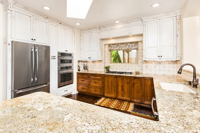Mid-sized mountain style u-shaped dark wood floor eat-in kitchen photo in Albuquerque with a double-bowl sink, shaker cabinets, granite countertops, beige backsplash, ceramic backsplash and stainless steel appliances