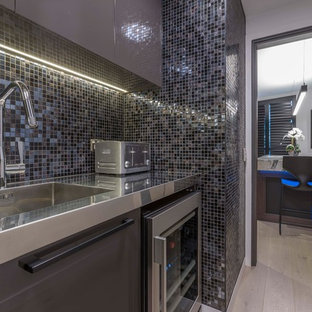 Large contemporary kitchen pantry pictures - Inspiration for a large contemporary l-shaped beige floor and light wood floor kitchen pantry remodel in Hamilton with an integrated sink, flat-panel cabinets, brown cabinets, stainless steel countertops, multicolored backsplash, mosaic tile backsplash, stainless steel appliances and no island