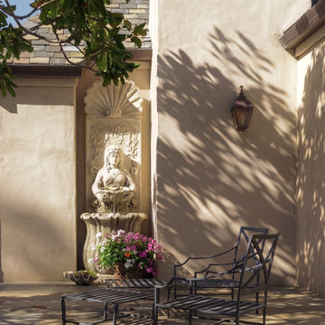 Courtyard seating with wall fountain in Pebble Beach garden