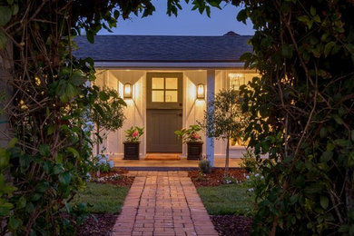 Inspiration for a mid-sized coastal white one-story wood exterior home remodel in Santa Barbara with a shed roof