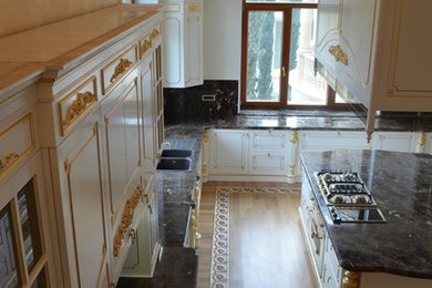 This is an example of an expansive traditional kitchen in Other with flat-panel cabinets and medium hardwood floors.