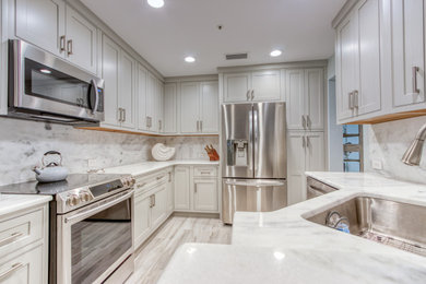 Example of a small trendy galley porcelain tile and gray floor eat-in kitchen design in Miami with a single-bowl sink, beaded inset cabinets, gray cabinets, granite countertops, gray backsplash, stone slab backsplash, stainless steel appliances and gray countertops