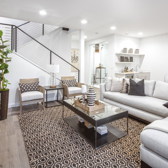The lower level is all about having fun.  The large room is great for lounge seating and a game table.  The cable guardrail carried down from the main floor keeps the room feeling open.  The same hard